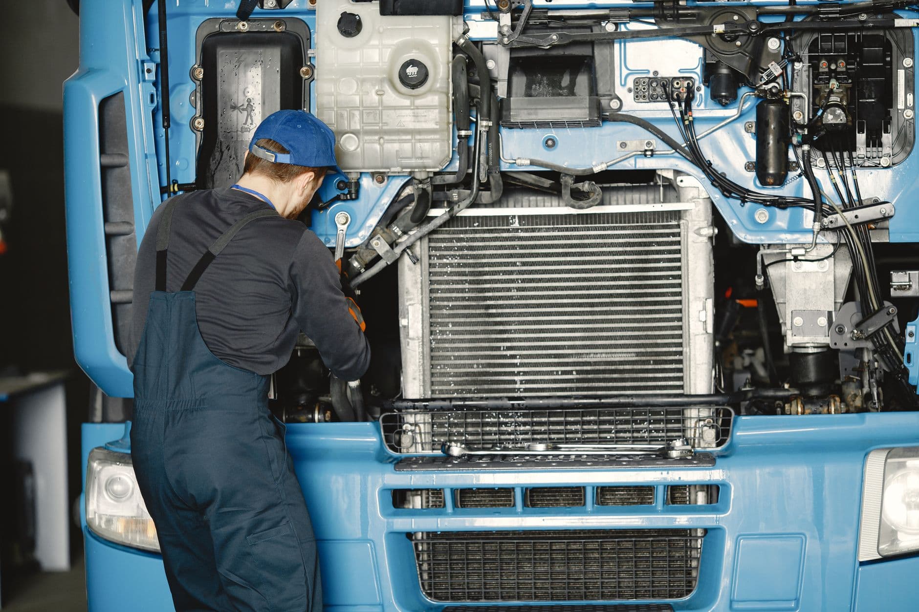 Mechanic servicing a truck engine
